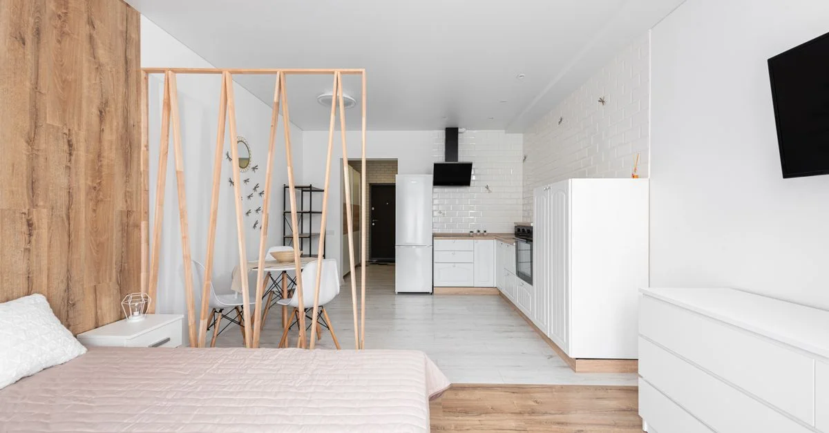 Appartement studio à agencement ouvert avec mobilier moderne et accents en bois.